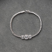 Imperia - Sophisticated Tennis Bracelet Featuring Central Emerald-Cut Lab Grown Diamond Stones in 18ct Gold